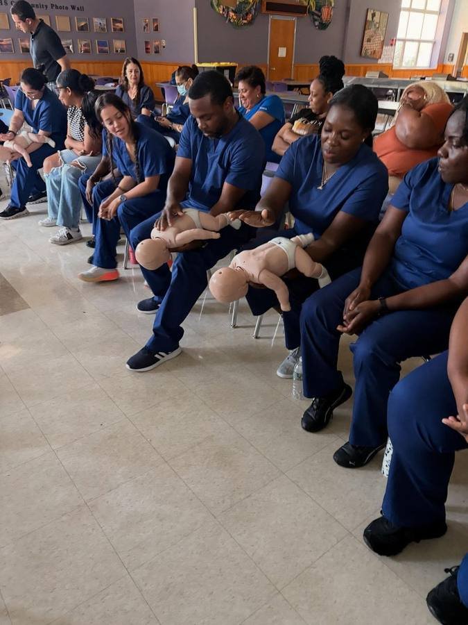 Group CPR compression practice on training mannequins
